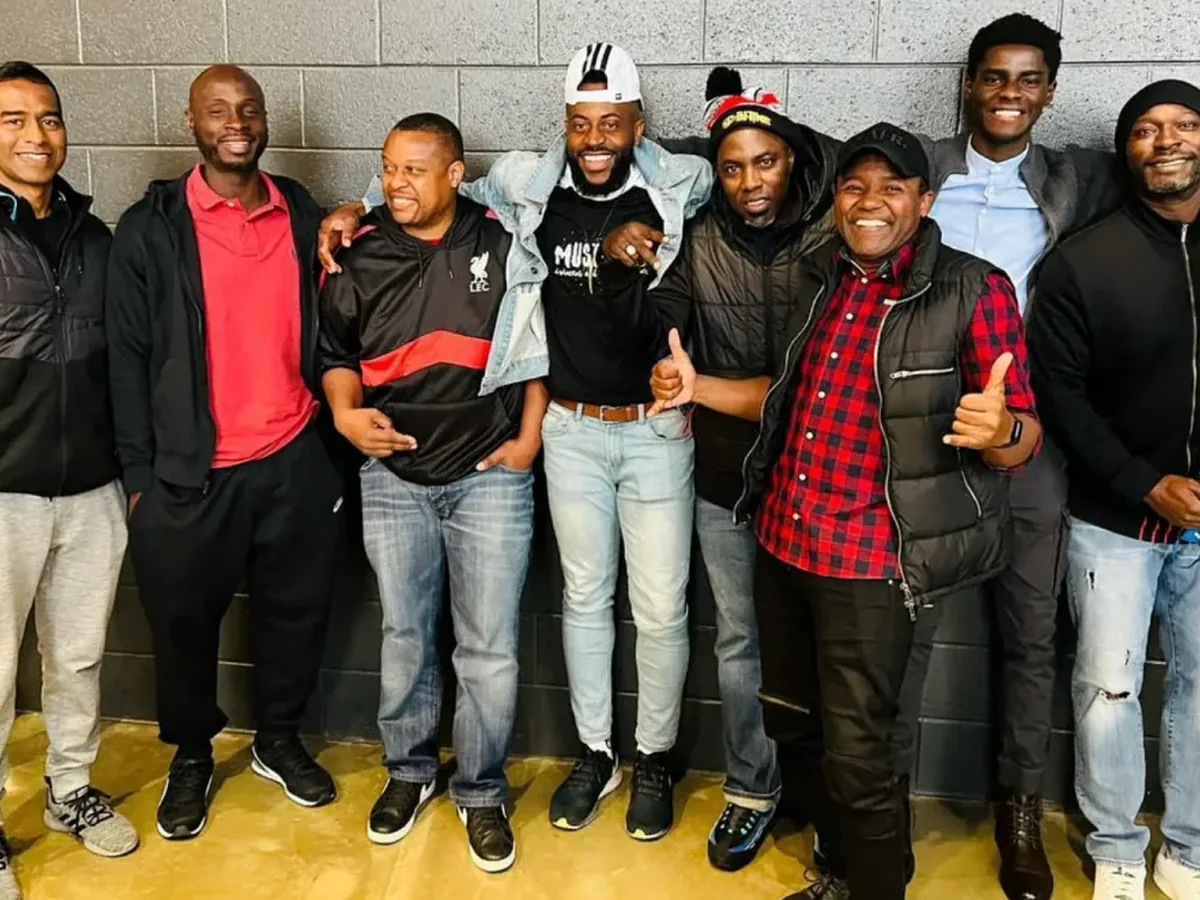 Group of community members and players smiling together after an indoor event